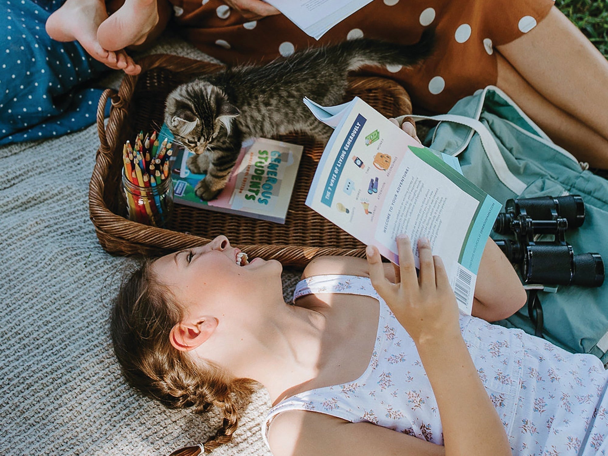 Smiling girl reading a Generous Family storybook with her cat nearby — faith-based story about gratitude for kids and thankfulness.
