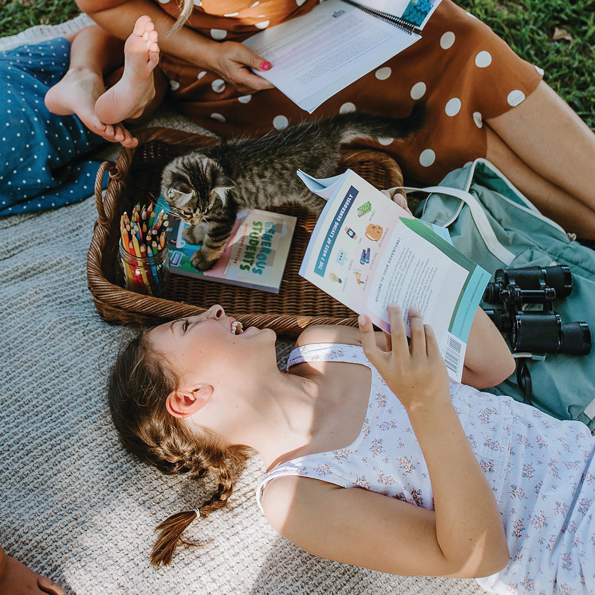 Smiling girl reading a Generous Family storybook with her cat nearby — faith-based story about gratitude for kids and thankfulness.