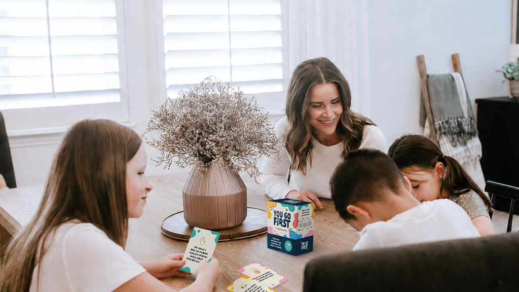 Family playing You Go First Christian conversation cards together at the dinner table