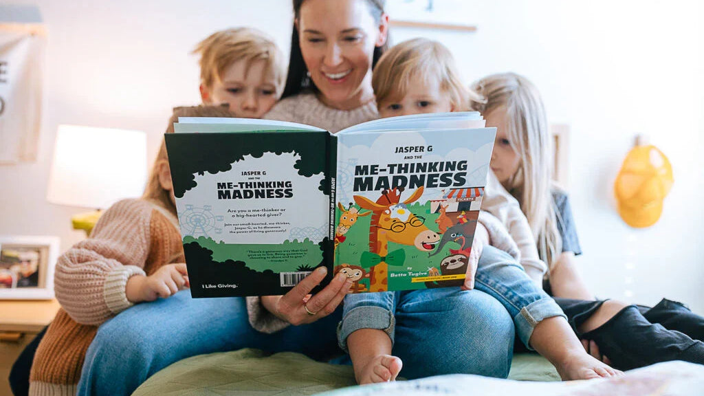 Mom reading a Generous Family book with three kids cuddled on the couch, a screen-free family moment
