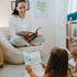 Woman reading a book to two children