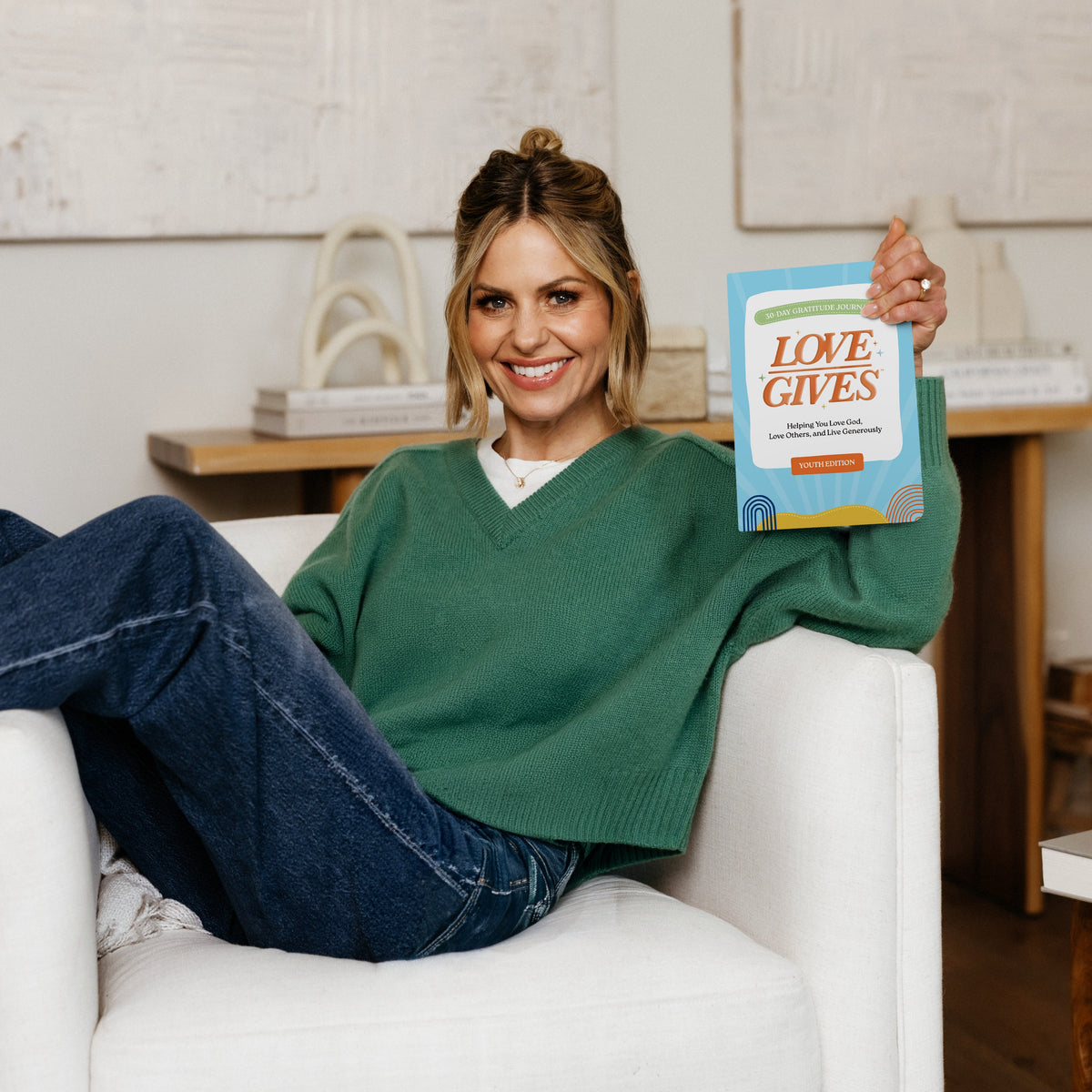 Candace Cameron Bure holding the Love Gives Youth Edition Gratitude Journal